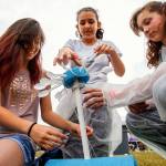 A team of three Haller Middle School sixth-graders nears completion on construction of a wind-turbine they created to generate power in a large mock Mars colony. The girls are (from left) Isabelle Gutierrez, Angelina Vasquez and Rihanna Sahnow. (Dan Bates / The Herald)