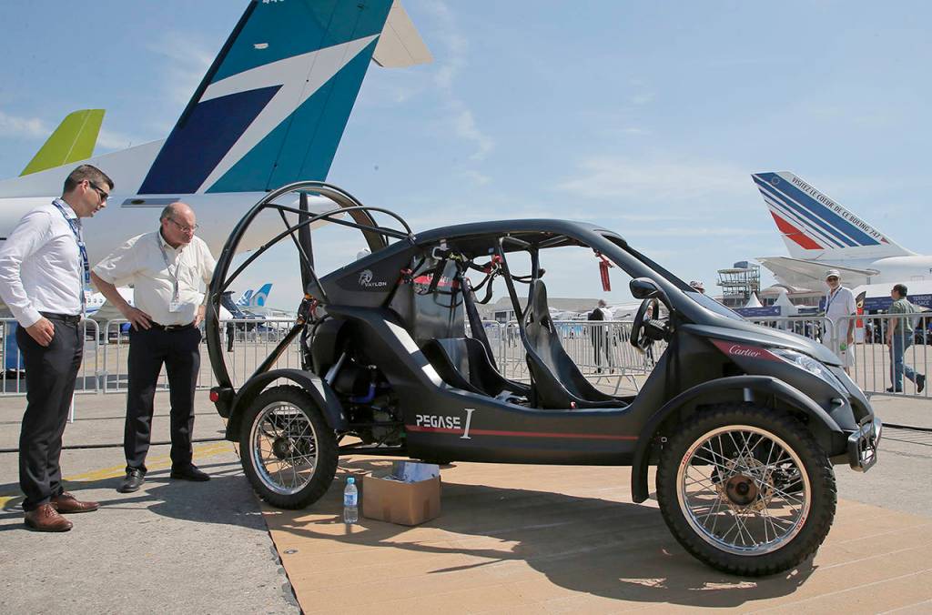 Visitors look at the flying car Pegasus 1, built by French entrepreneur Jerome Dauffy, at the Paris Air Show in Le Bourget on Tuesday, June 20. (AP Photo/Michel Euler)