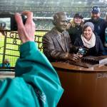 Mystery Merwine (from left), Keira Merwine, Matt Merwine and Madison Merwine pose for a photo with the statue of Mariners sportscaster Dave Niehaus at Safeco Field. (Kevin Clark / The Herald)