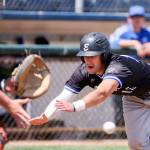 The Merchants&rsquo; Max Whitt beats the tag attempt by Kitsaps&rsquo; Nash Gowin during a game June 4, 2017, at Everett Memorial Stadium. (Kevin Clark / The Herald)