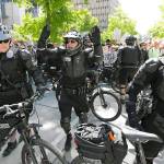 Seattle Police officers shout as they try to separate protesters from counter-protesters at an anti-Islamic law rally Saturday, June 10, in Seattle. (AP Photo/Ted S. Warren)