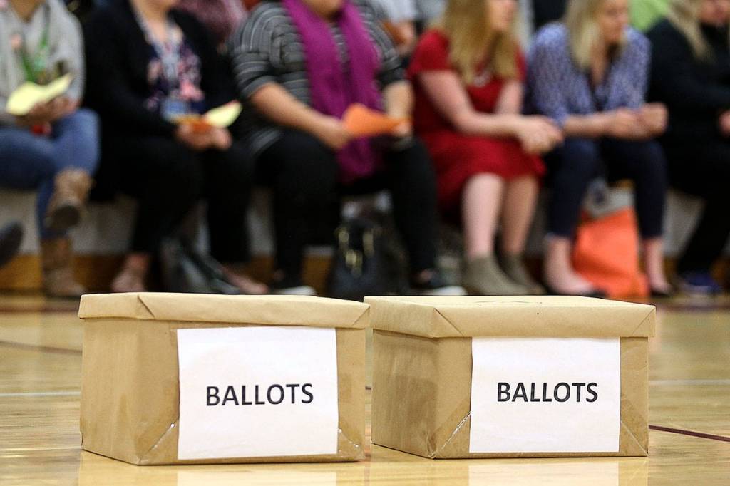 Ballot boxes await the vote but were not used because the vocal vote to authorize a strike was unanimous. (Kevin Clark / The Herald)