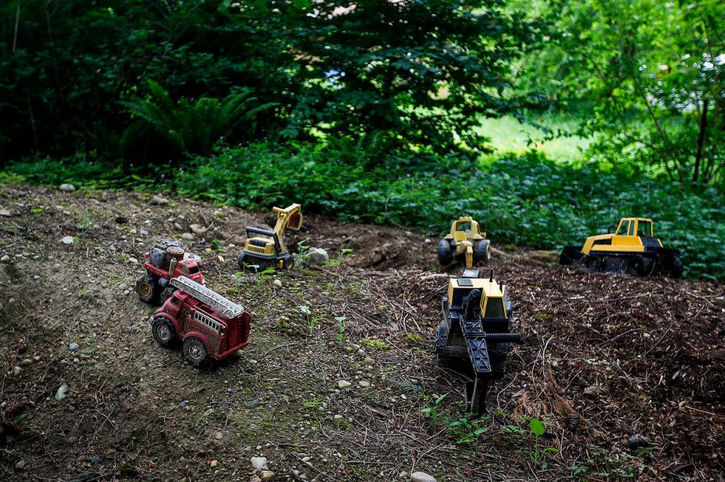 Kids toys resemble a scene from nearby housing development construction near the Songaia community in Bothell. (Ian Terry / The Herald)