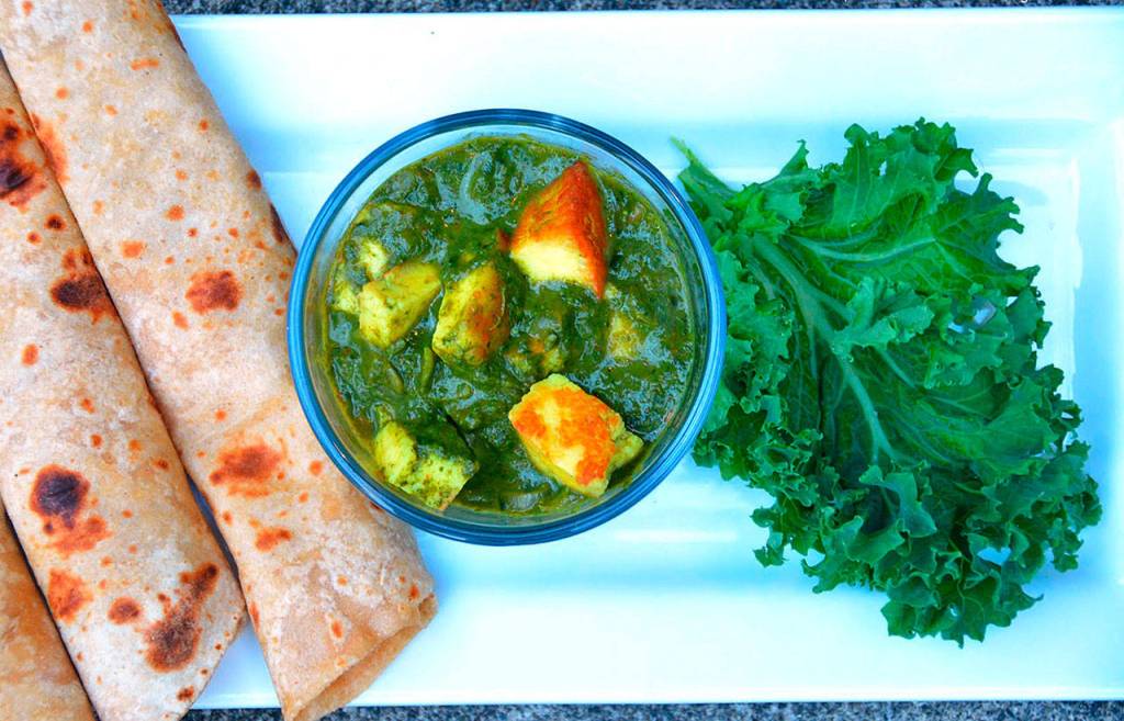 Kale and cheese cubes in a creamy curry (kale paneer) is a twist on the classic spinach and cheese curry (palak paneer).. (Photo by Reshma Seetharam)