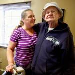 Williams gets a hug from Tammee Hindman, manager at the Woodbrook Apartments. The complex on 112th Street SE is a daily stop. Hindman has become a close friend of Williams. (Dan Bates / The Herald)