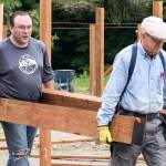 Joel Bockovich and Kim Daughtery haul timbers. (Kevin Clark / The Herald)