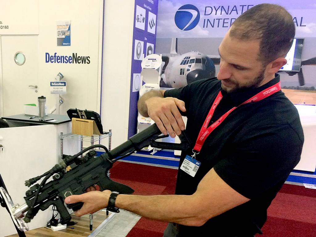 David Romero, of the Boise, Idaho-based firm Black Sage, showcases a drone-zapping gun that is part of an anti-drone system his firm is displaying at the Paris Air Show on Tuesday, June 20, in Le Bourget. The proliferation of unmanned aircraft is increasing concerns that terrorists could use drones to attack crowds at sports stadiums and other events. (AP Photo/John Leicester)