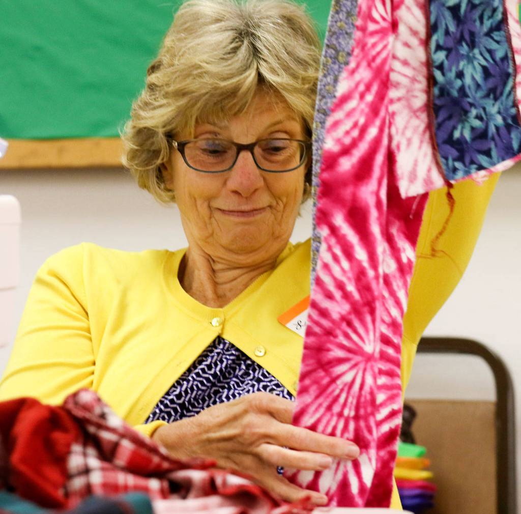 Lynda Batchelor sews sews components of liners for hygiene kits women around the world for Saturday morning at Bethel Baptist Church in Everett on June 17, 2017. (Kevin Clark / The Herald)