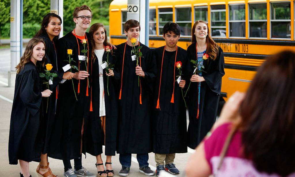Upon returning to their bus after the senior walk, some of the Monroe seniors posed for pictures outside Chain Lake Elementary School. They are (from left) Jordan Roche, Kittra Evenson, Ethan Medlin, Sidney Anderson, Graydon Fuller, Simon Hayashi and Alyssa Park. (Dan Bates / The Herald)