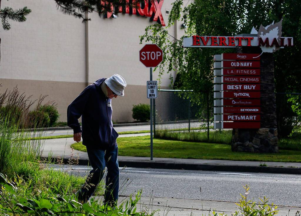 After walking past the Everett Mall, Williams makes his way to 100th Street SE. Since May 2, 2002, Williams has walked six miles each day, always following the same routes. (Dan Bates / The Herald)