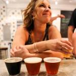 Megan Eison tries four samples at Scrappy Punk Brewery. (Kevin Clark / The Herald)