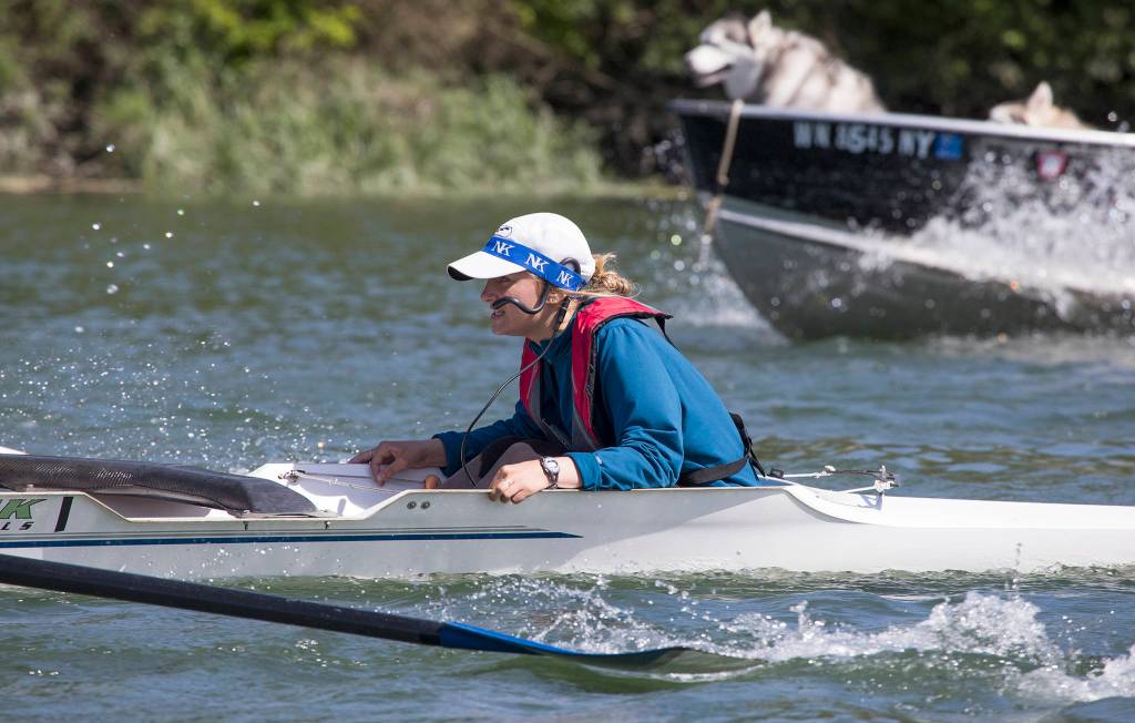 Everett Rowing Association coxswain Summer Keyes calls out timing, steers the boat and talks to her crew as they practice on the Snohomish River on June 5 in Everett. (Andy Bronson / The Herald)