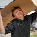 Logan Marson hauls cardboard for newly constructed garden beds at Eagle Ridge Park in Lake Stevens on June 3. (Kevin Clark / The Herald)