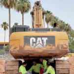 A construction crew sits under their excavator during a break to avoid the heat Tuesday in Tempe, Arizona. (AP Photo/Matt York)