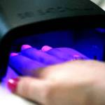 Instead of air drying, gel nail polish is cured under an LED light. (Vanessa McVay / The Herald)