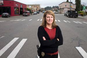 Monroe Police Department&rsquo;s Detective Sgt. Cindy Chessie stands along Main Street on Wednesday in Monroe. Chessie is retiring to become director of the Sky Valley Food Bank. (Andy Bronson / The Herald)