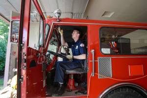 Volunteer firefighter Scott Murphy, of Federal Way, goes through a rig check in 2012 on Hat Island. The Hat Island fire department is entirely staffed by volunteers. The rigs in the fleet date back to the 1980s and earlier. Soon they are getting a 1991 model, formerly used in Machias. (Sara Weiser / The Herald)