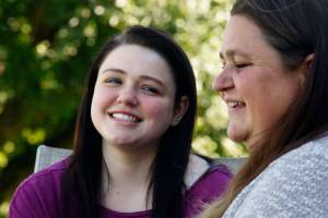 Recent AIM High School graduate Dakota Mowry, 18, talks with her mom, Crystal Scholl, at the family home in Snohomish Wednesday. Scholl was pregnant when she started at AIM, and baby Dakota, born in 1999, was cared for at the school&rsquo;s child-care center. Scholl graduated from AIM in 2000. (Dan Bates / The Herald)