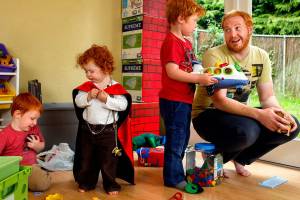 In their basement playroom Thursday morning, Alex Clawson, 32, communicates firmly and thoughtfully with his eldest son, Willem, 4 while son Atley, 3 (left) plays with 20-month-old daughter Seirsha, who is wearing a Spider-Man cape. Clawson&rsquo;s wife and the children&rsquo;s mother, Amy Clawson, 33, as well as newborn daughter Elayda, died May 21 after Amy suffered heart failure. (Dan Bates / The Herald)