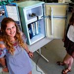 Lake Stevens High School seniors Isabelle Eelnurme (left) and Elise Gooding converted an old refrigerator to a hydroponic garden for their engineering design class. Their award-winning device is for growing healthy, nutritious produce in food deserts. (Dan Bates / The Herald)