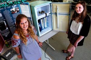 Lake Stevens High School seniors Isabelle Eelnurme (left) and Elise Gooding converted an old refrigerator to a hydroponic garden for their engineering design class. Their award-winning device is for growing healthy, nutritious produce in food deserts. (Dan Bates / The Herald)
