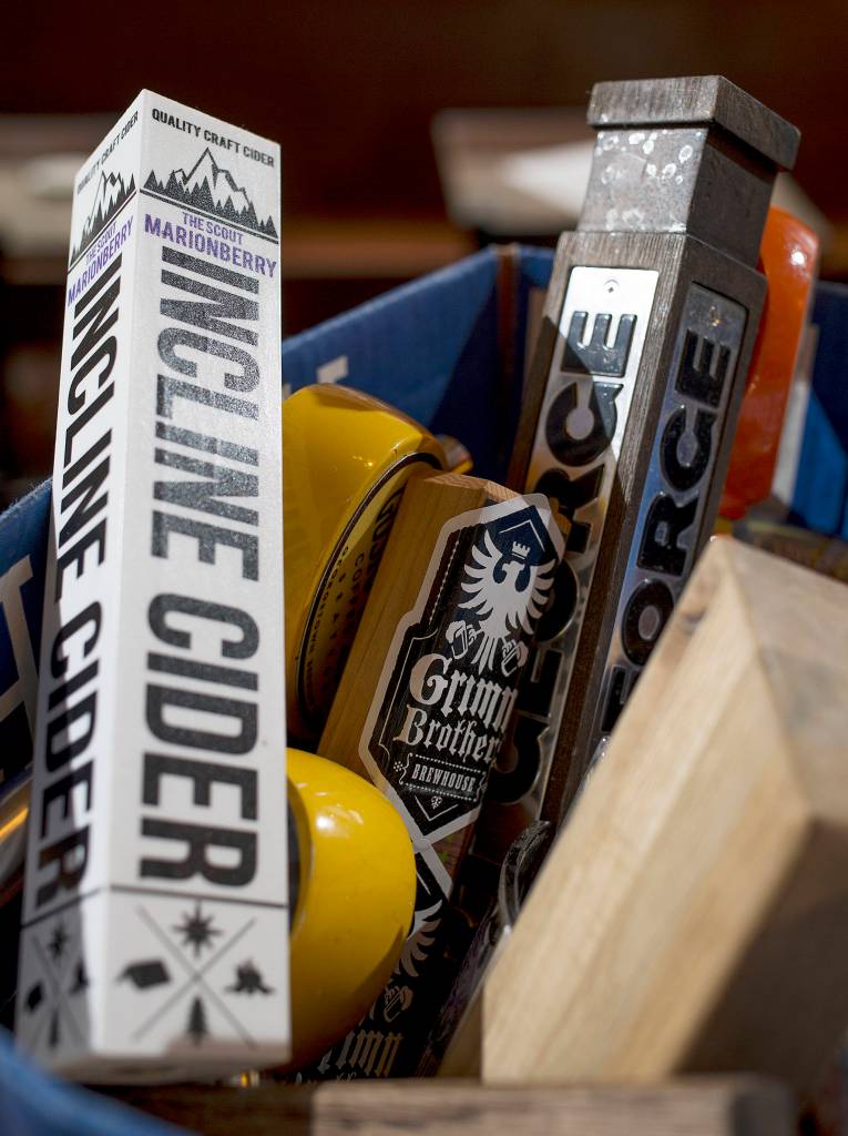 Beer tap handles in sit in alphabetical boxes at The Independent on Hewitt Avenue on April 7 in Everett. (Andy Bronson / The Herald)