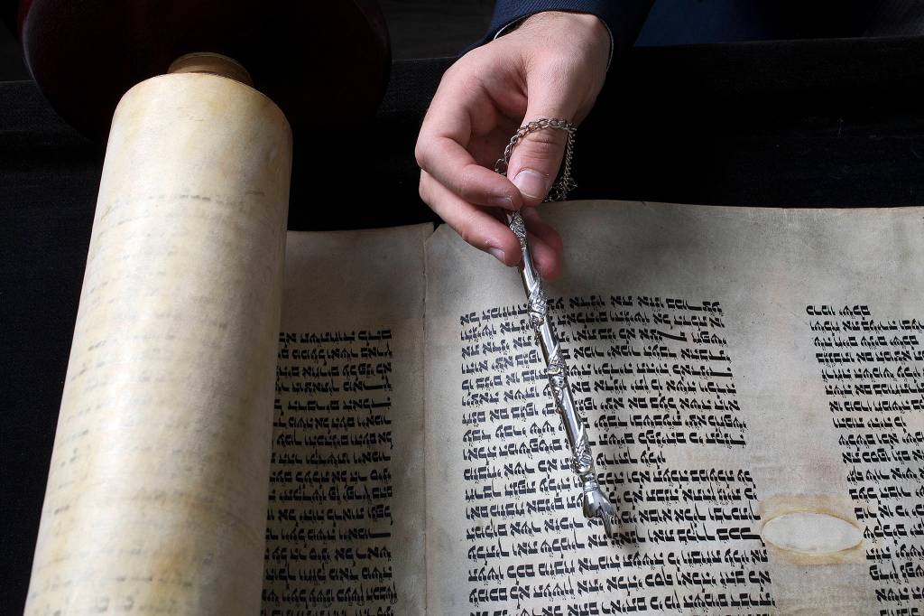 Rabbi Berel Paltiel holds a yad, used to help the reader follow the text of a Torah, at the Chabad Jewish Center of Snohomish County on May 30 in Lynnwood. (Andy Bronson / The Herald)