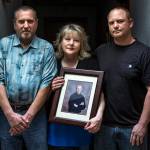 Debra Willard holds a portrait of her son Dustin along with her husband Larry (left) and son Clint. Dustin Willard was shot and killed by Everett police officers in November of 2008 at the home he owned with his brother on 23rd Street in Everett. (Ian Terry / The Herald)