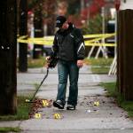 An Everett Police Department investigator searches for evidence at the scene of the shooting on Nov. 8, 2008. (Mark Mulligan / The Herald, file)