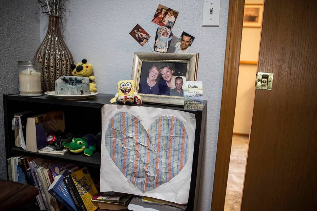 A heart with messages written to Dustin Willard is seen along with old photographs in his mother Debra&rsquo;s bedroom. &ldquo;I keep it here so it&rsquo;s the first thing I see when I wake up each morning,&rdquo; Debra said. (Ian Terry / The Herald)