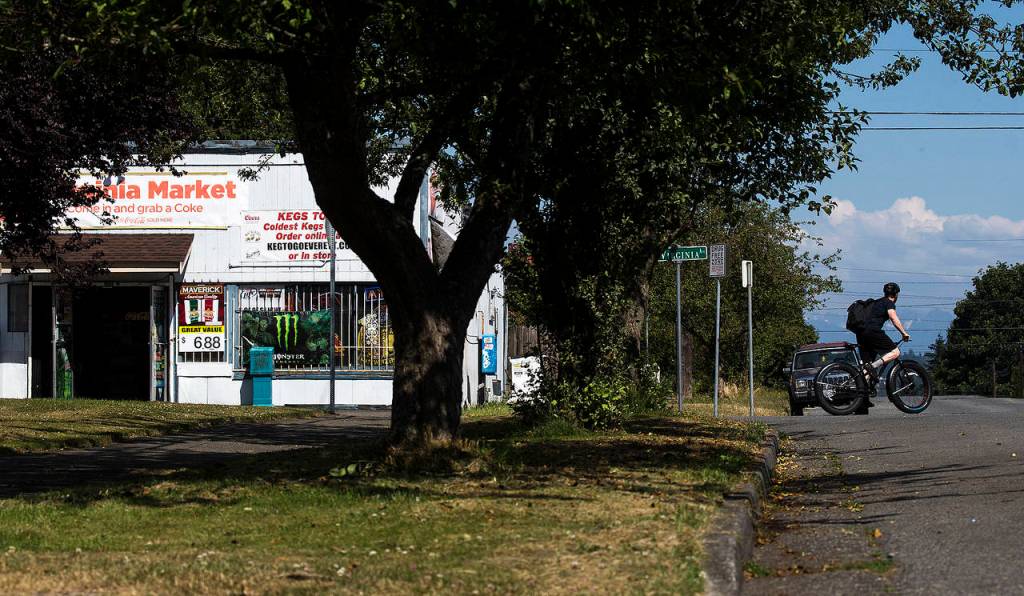 On a recent day, a cyclist crosses 23rd Street in Everett near the house Dustin and Clint Willard owned together before Dustin was shot and killed by Everett police officers on Nov. 8, 2008. (Ian Terry / The Herald)