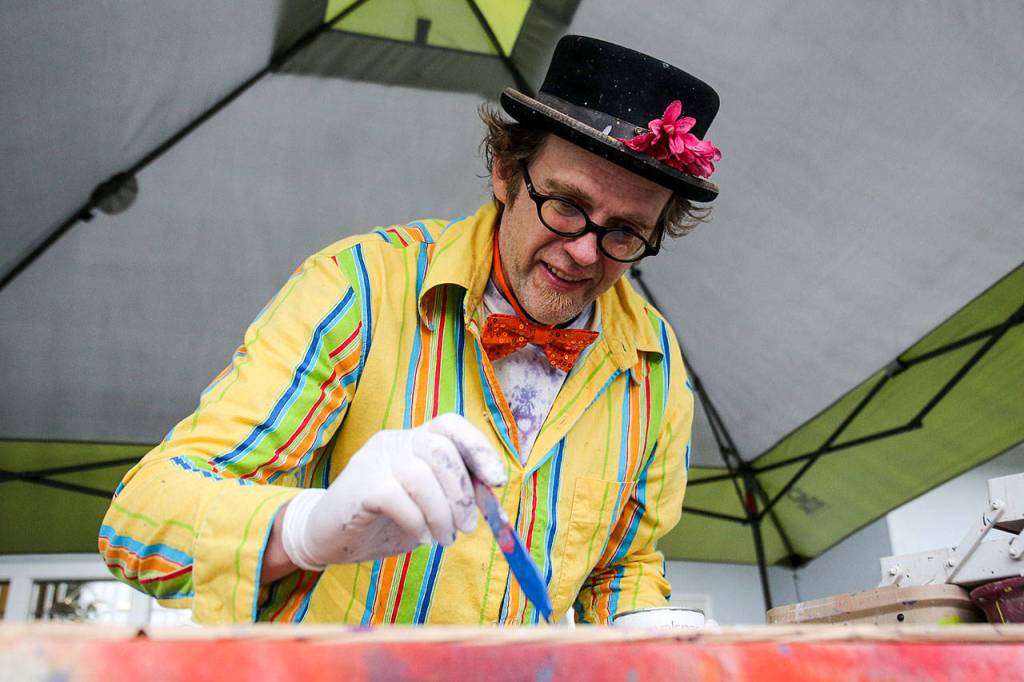 Ball paints outside Solie Funeral Home & Crematory as part of the Everett Art Walk. (Kevin Clark / The Herald)