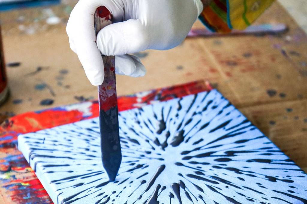 Ball paints outside Solie Funeral Home & Crematory as part of the Everett Art Walk. (Kevin Clark / The Herald)