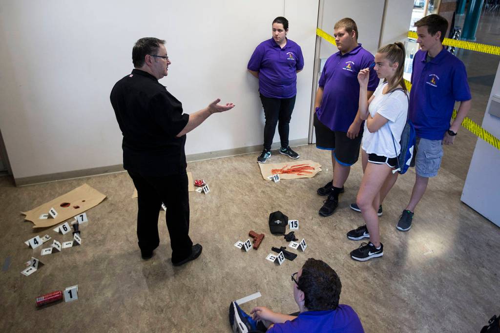 Mukilteo Youth Police Academy students learn about crime scene forensics at Kamiak High School on Thursday. (Ian Terry / The Herald)