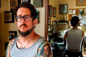 Michael Gardner, 45, of Snohomish was recently scammed out of $3,000 by callers who said he&rsquo;d be arrested for missing jury duty. Gardner, who owns a tattoo business in Everett, wants to warn others to beware of official sounding callers. (Dan Bates / The Herald)