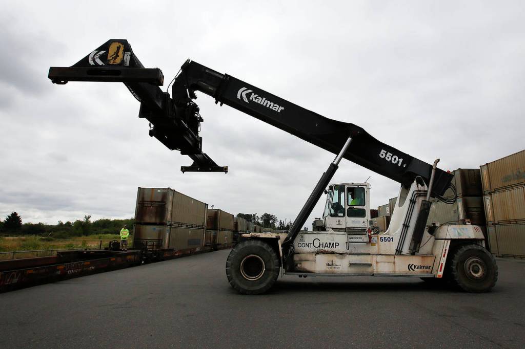 A top pick lift is seen before loading a container onto a train in Everett on Tuesday. (Ian Terry / The Herald)
