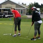 Beck Buerhaus (left) and Carla Carson attempt to sink putts at Harbour Pointe Golf Club during the Amazing Race Mukilteo last year. (Submitted photo)