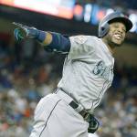 Seattle&rsquo;s Robinson Cano (22) celebrates while rounding the bases after hitting a home run in the 10th inning of the MLB All-Star Game Tuesday in Miami. Cano&rsquo;s homer gave the American League a 2-1 win in 10 innings and earned the Mariners star MVP honors. (Lynne Sladky / Associated Press)