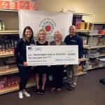 Washington Kids in Transition was awarded a $10,000 donation from Insurance Services Group through the 2017 Safeco Insurance Make More Happen Award program. Pictured from left are Kiersten Christensen, of Insurance Services Group; Mary Gardner, of Safeco Insurance; Kim Gorney, of Washington Kids in Transition, and Trevor Campbell, of Insurance Services Group. (Contributed photo)