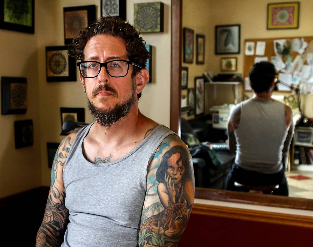 Michael Gardner, 45, of Snohomish was scammed out of $3,000 by callers who said he&rsquo;d be arrested for missing jury duty. Gardner, who owns a tattoo business in Everett, wants to warn others to beware of official sounding callers. (Dan Bates / The Herald)