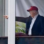 President Donald Trump reacts to spectators as he watches the third round of the U.S. Women&rsquo;s Open Golf tournament from his observation booth Saturday in Bedminster, New Jersey. (AP Photo/Seth Wenig)