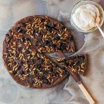 Castagnaccio is a chestnut flour cake with pine nuts and golden raisins. When serving a slice, top it with a dollop of ricotta cream. (Photo by Lauren Bamford)