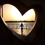 In this 2014 photo, a Saudi woman seen through a heart-shaped statue walks along an inlet of the Red Sea in Jiddah, Saudi Arabia. (AP Photo/Hasan Jamali, File)