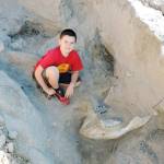 Jude Sparks poses with the Stegomastodon fossil he stumbled across near Las Cruces, New Mexico. (Peter Houde / New Mexico State University)