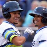 The AquaSox&rsquo;s Joseph Rose makes his way to the dugout after scoring on a Boise error on July 21, 2017, at Everett Memorial Stadium. (Kevin Clark / The Herald)