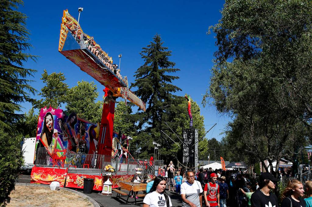 Crowds walk through the carnival area of Aquafest in downtown Lake Stevens on Friday. (Ian Terry / The Herald)