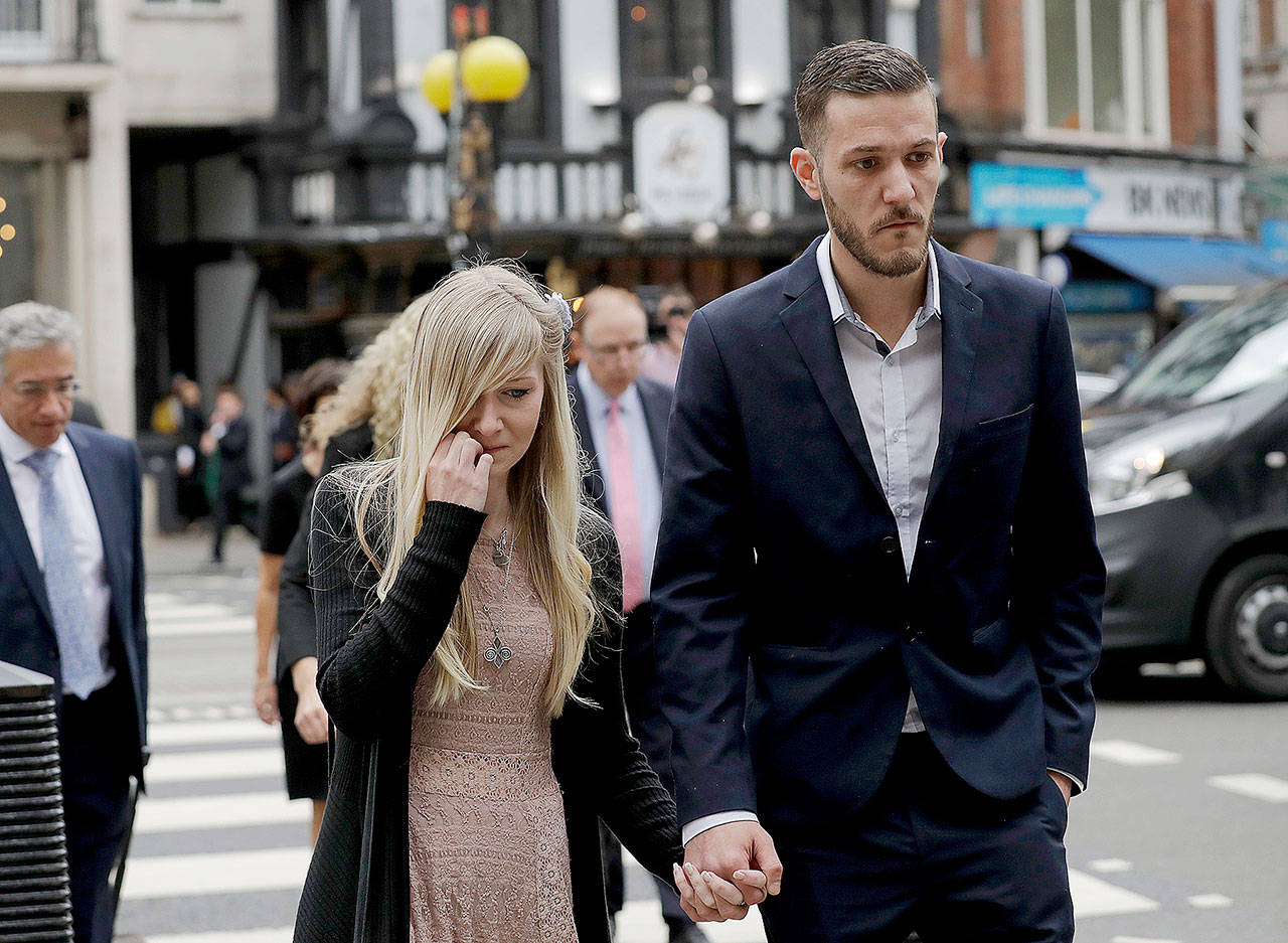 The parents of critically ill baby Charlie Gard, Connie Yates and Chris Gard, arrive at the High Court in London on Monday. (AP Photo/Matt Dunham)