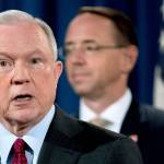 Attorney General Jeff Sessions (left), accompanied by Deputy Attorney General Rod Rosenstein (right), speaks at a news conference to announce an international cybercrime enforcement action at the Department of Justice, on July 20 in Washington. (AP Photo/Andrew Harnik)