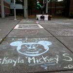 Messages and drawings written in chalk Thursday at Jackson High School commemorate the lives of three teens killed in a car crash Wednesday in Lynnwood. (Ian Terry / The Herald)