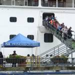 Passengers of the Emerald Princess cruise ship disembark Wednesday in Juneau, Alaska, hours after arriving at port. (AP Photo/Becky Bohrer)